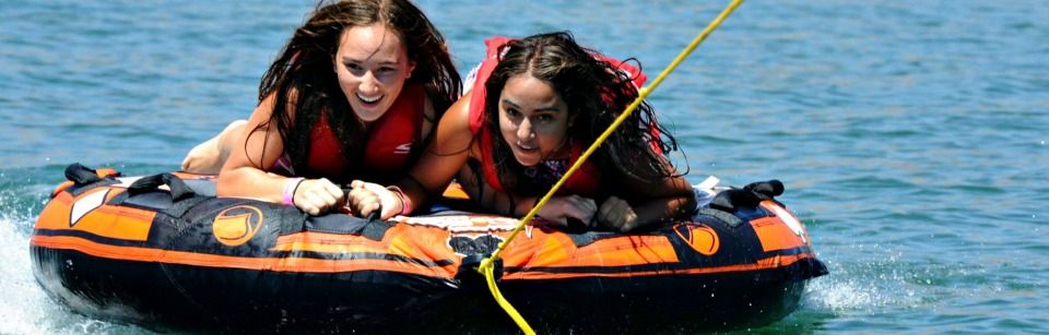 Two teenage girls tubing at Aloha Beach Camp.
