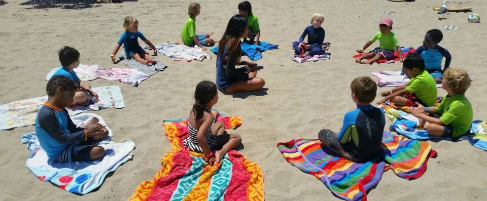 Boys and girls playing the Musical Beach Towel game at Aloha Beach Camp's Keiki Camp summer program. Providing an introduction to the beach and ocean activities at Zuma Beach and Paradise Cove in Malibu, Aloha Beach Camp's Keiki Camp program is widely considered one of the top summer day camps for preschool-age children in the Los Angeles area.
