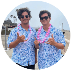 Kahuna and High Action Camp directors Josh and Noah Naftulin standing together on the beach.