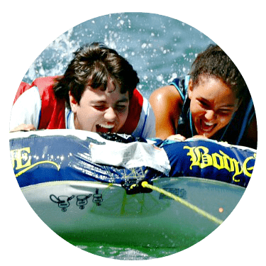 Teenage boy and girl tubing at Aloha Beach Camp