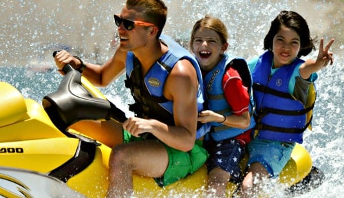 Two happy kids jet skiing with their camp counselor at Aloha Beach Camp summer day camp in Los Angeles