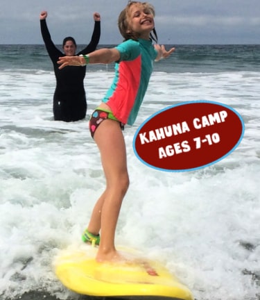 Kahuna Camper surfing with counselor in the background