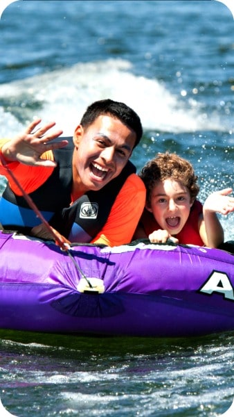Camper and counselor from Agoura Hills tubing together at Castaic Lake