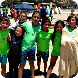 Group of Aloha Beach Camp's Cheviot Hills summer camp kids standing together on Zuma Beach.