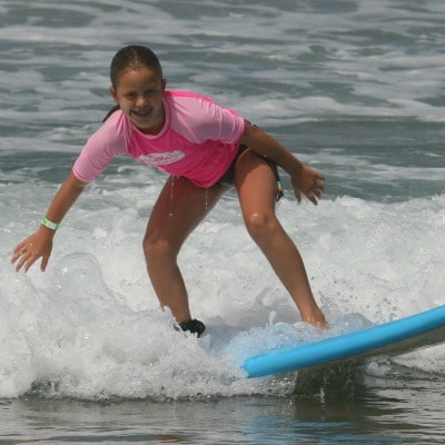 11 year old camper at Aloha Beach Camp surfing