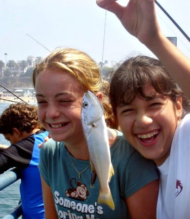Two girls fishing at Aloha Beach Camp