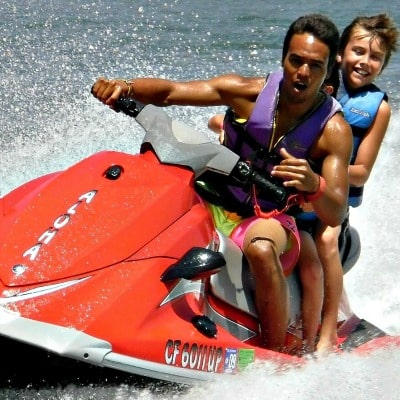 Boy and his camp counselor jet skiing at Aloha Beach Camp