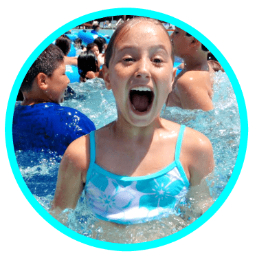 Happy camper (10 year old girl) swimming at Aloha Beach Camp's pool