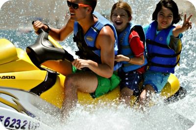 Aloha Beach Camp counselor and campers enjoying a jet ski ride.