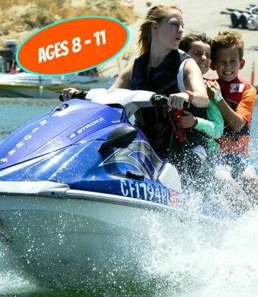 Two boys jet skiing with their camp counselor at Aloha Beach Camp