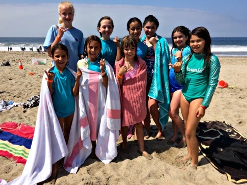 9 kids standing together on the beach at Aloha Beach Camp summer day camp in Los Angeles, CA