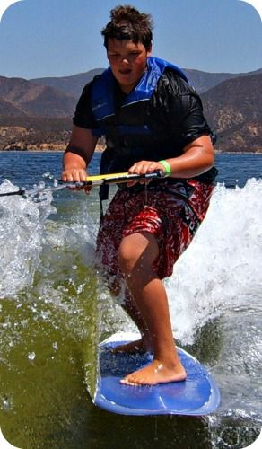 Boy wakeboarding at Aloha Beach Camp's Los Angeles summer wakeboarding camp