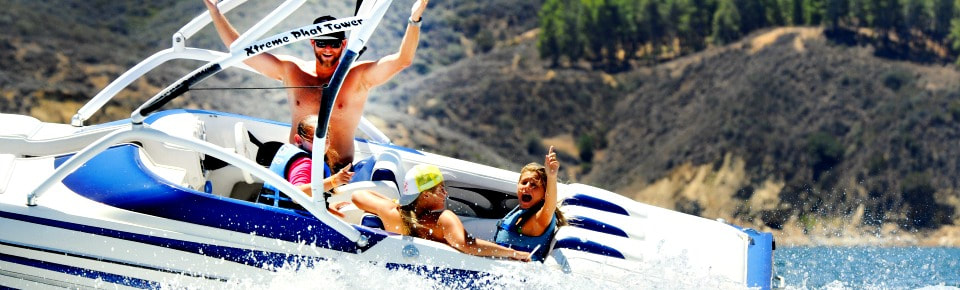 Three girls and their camp counselor enjoying a motor boat ride at Castaic Lake. Castaic Lake is just one of many aquatic day camp program locations Aloha Beach Camp  takes place in Los Angeles, California.