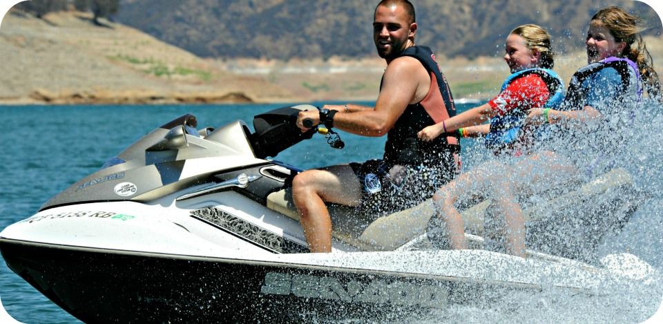 Camp director Kevin Khalili giving two female campers a jet ski ride at Castaic Lake.