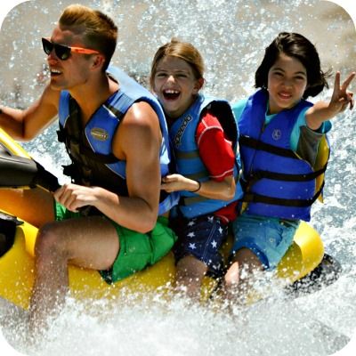 Two campers from Sherman Oaks and their camp counselor riding a jet ski at Aloha Beach Camp.
