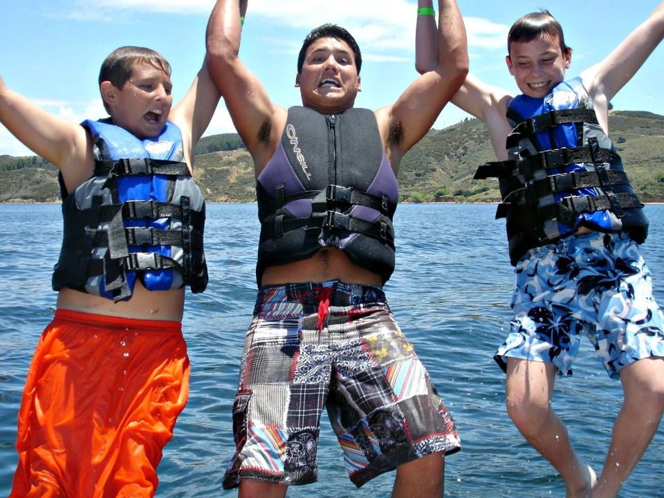 Two High Action Campers from Studio City jumping into the Lake with the Camp Counselor at Aloha Beach Camp