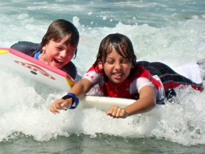 Two boys boogie boarding together